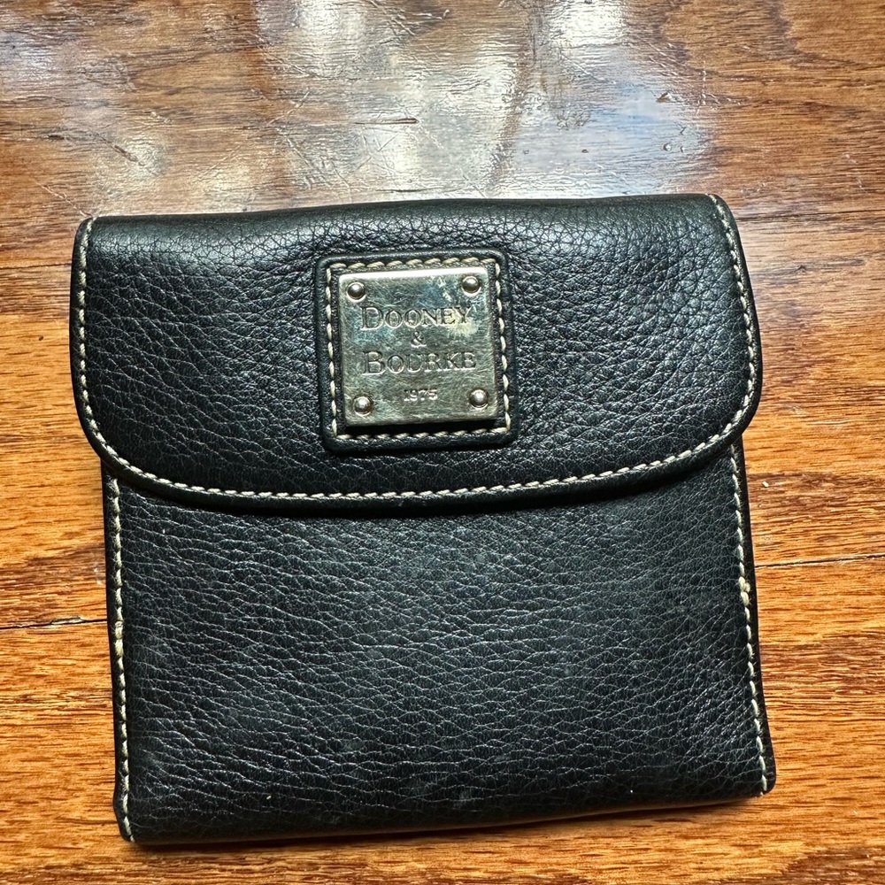 Dooney & Bourke pebble grain flap wallet a metal logo plate & contrast stitching